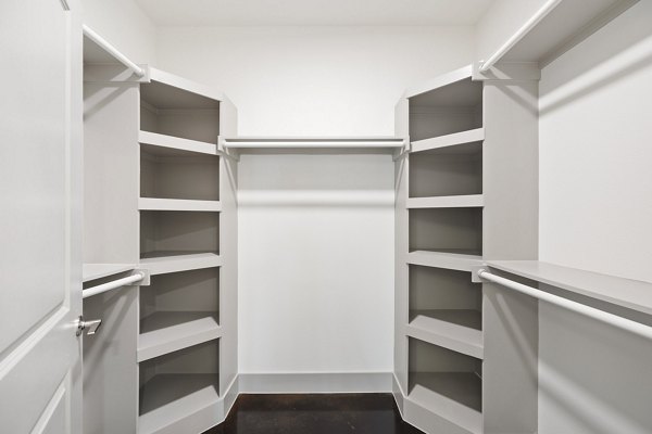 Walk-in closet with custom shelving in The Oliver Apartments