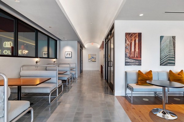 Modern clubhouse with cozy seating and billiards table at The Oliver Apartments, offering luxury living experiences in a vibrant community