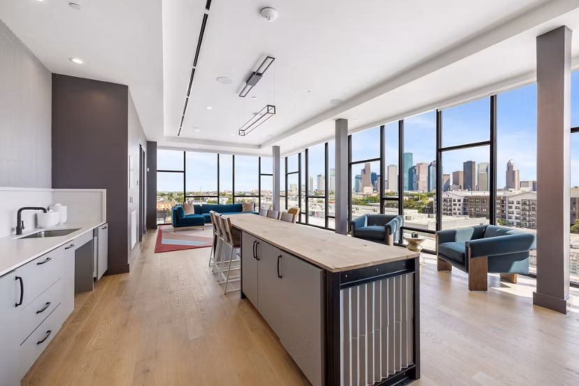 Clubhouse with modern seating and game tables at The Oliver Apartments, offering luxury amenities and social spaces for residents