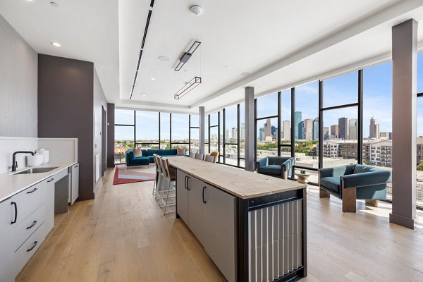 Clubhouse with modern seating and game tables at The Oliver Apartments, offering luxury amenities and social spaces for residents