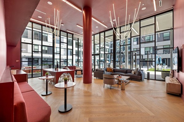 Elegant clubhouse with modern seating and lighting at The Oliver Apartments, perfect for socializing and relaxation