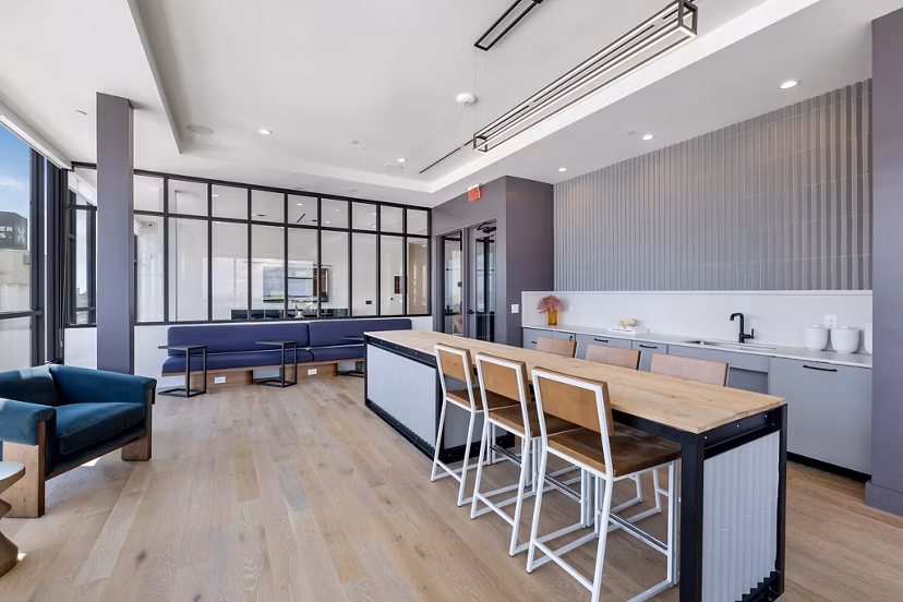Clubhouse with modern decor and ample seating at The Oliver Apartments, ideal for social gatherings and community events