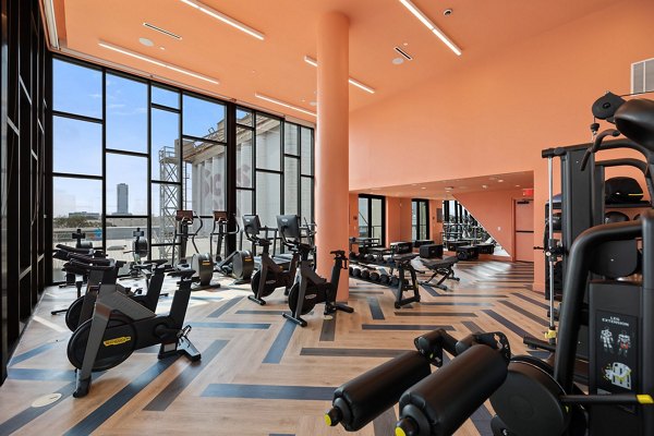 Fitness center with modern equipment at The Oliver Apartments, offering a high-quality exercise experience for residents seeking luxury living
