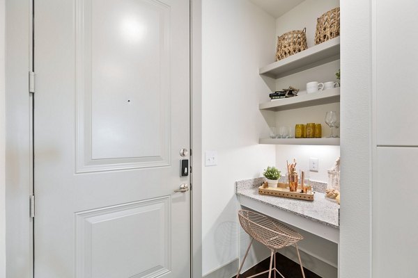 Home office with ergonomic desk and chair in The Oliver Apartments, perfect for remote work in a luxury setting