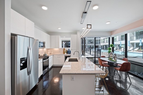 Modern kitchen with stainless steel appliances at The Oliver Apartments