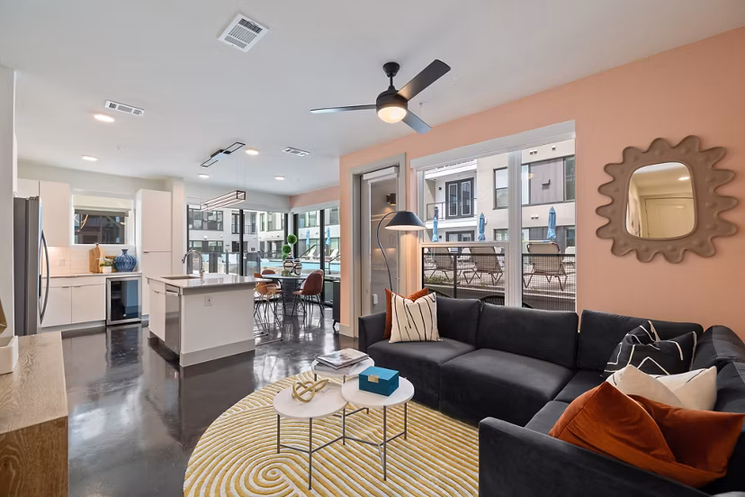 Spacious living room with modern decor in The Oliver Apartments, luxury housing option
