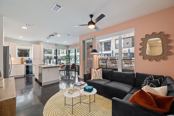 Spacious living room with modern decor in The Oliver Apartments, luxury housing option