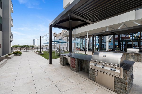 Outdoor grill area with stainless steel appliances at The Oliver Apartments, perfect for gatherings and cooking in style