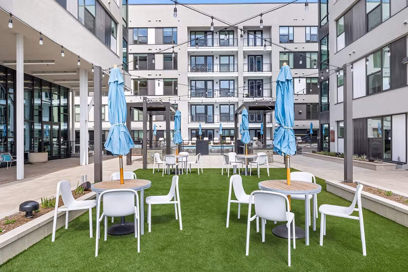 Courtyard with lush greenery at The Oliver Apartments, offering serene outdoor spaces for residents