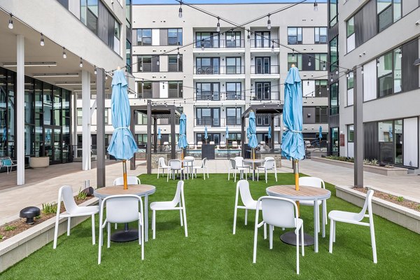 Courtyard with lush greenery at The Oliver Apartments, offering serene outdoor spaces for residents