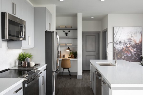 Modern kitchen with stainless steel appliances at Broadstone Bryson Apartments