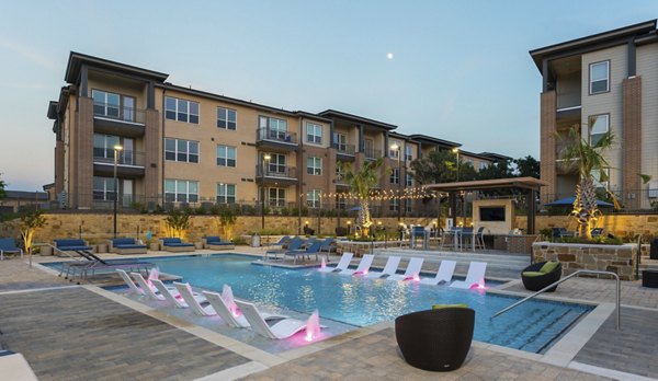 Outdoor pool with lounge chairs at Broadstone Bryson Apartments, a luxurious community with modern amenities in a vibrant setting