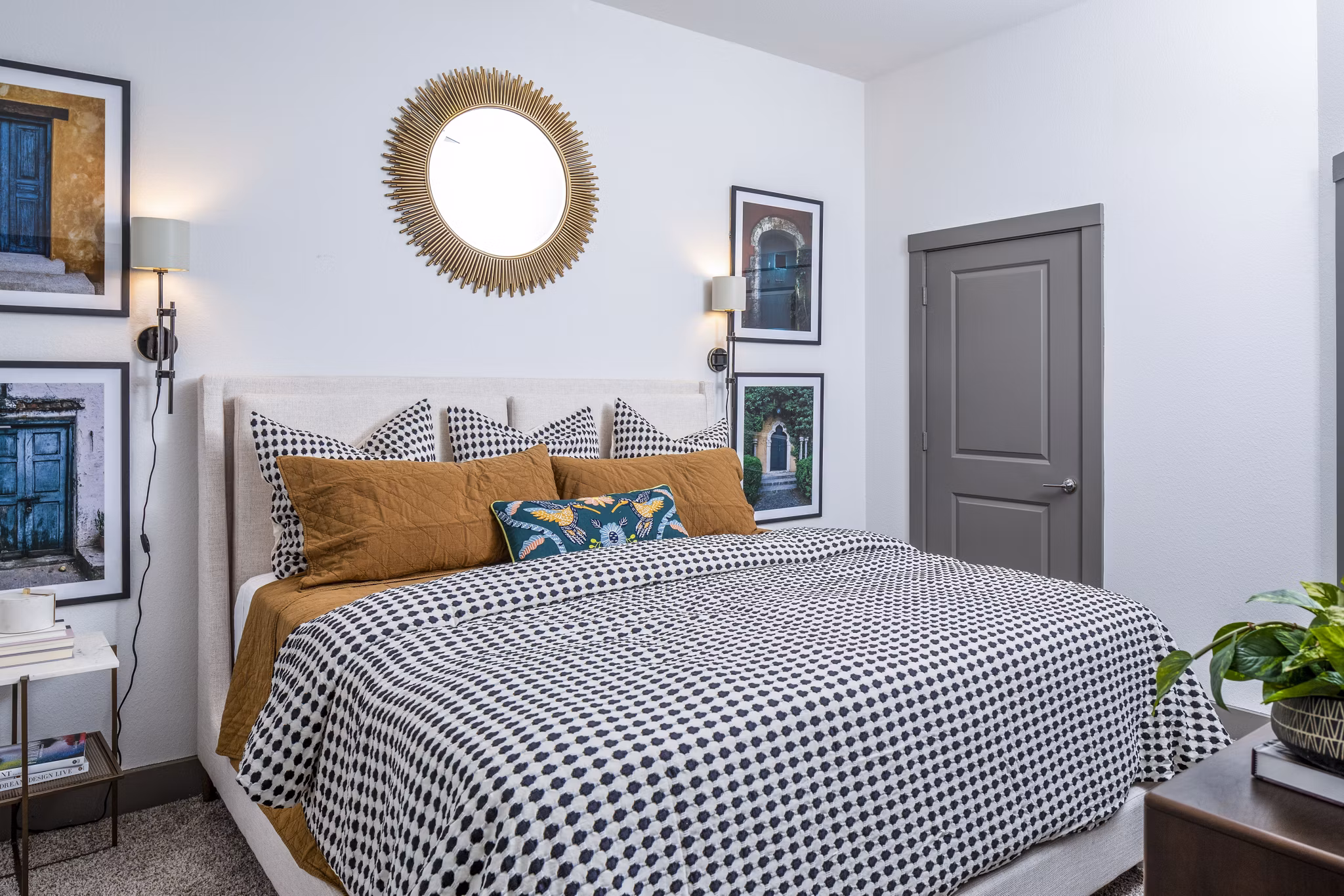Cozy bedroom featuring a stylish bed with patterned bedding and decorative pillows