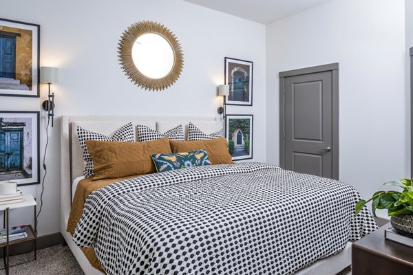 Cozy bedroom featuring a stylish bed with patterned bedding and decorative pillows