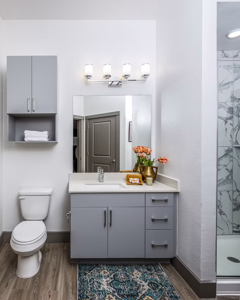 Modern bathroom featuring a glass shower and stylish vanity with decorative elements