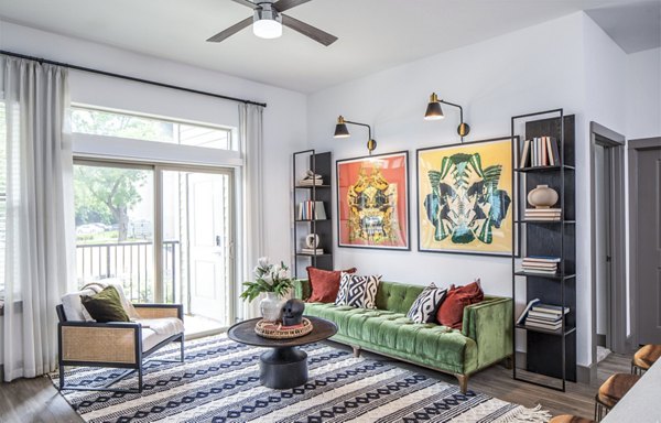 Modern living room featuring a green sofa and large window in luxury apartments