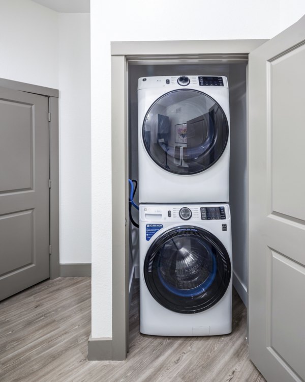 Stacked washer and dryer in a compact closet for luxury apartments