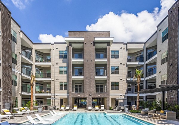 Luxury apartments with a sparkling swimming pool in front, perfect for relaxation and outdoor enjoyment