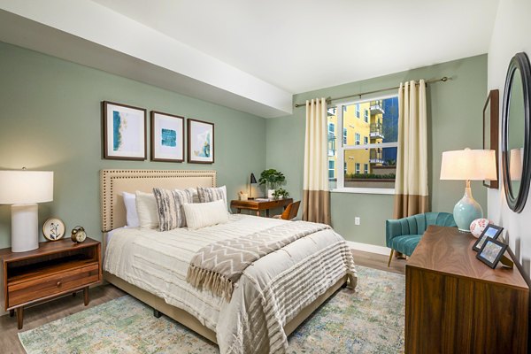 Aston at Gateway Apartments: Cozy bedroom with modern decor and ample natural light