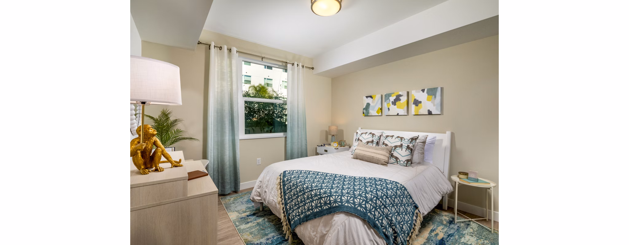Bedroom featuring modern decor and large windows in Aston at Gateway Apartments