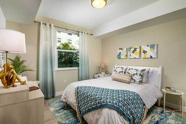 Bedroom featuring modern decor and large windows in Aston at Gateway Apartments