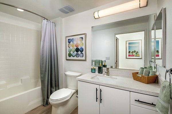 Modern bathroom with sleek finishes at Aston at Gateway Apartments, featuring a spacious vanity and contemporary fixtures