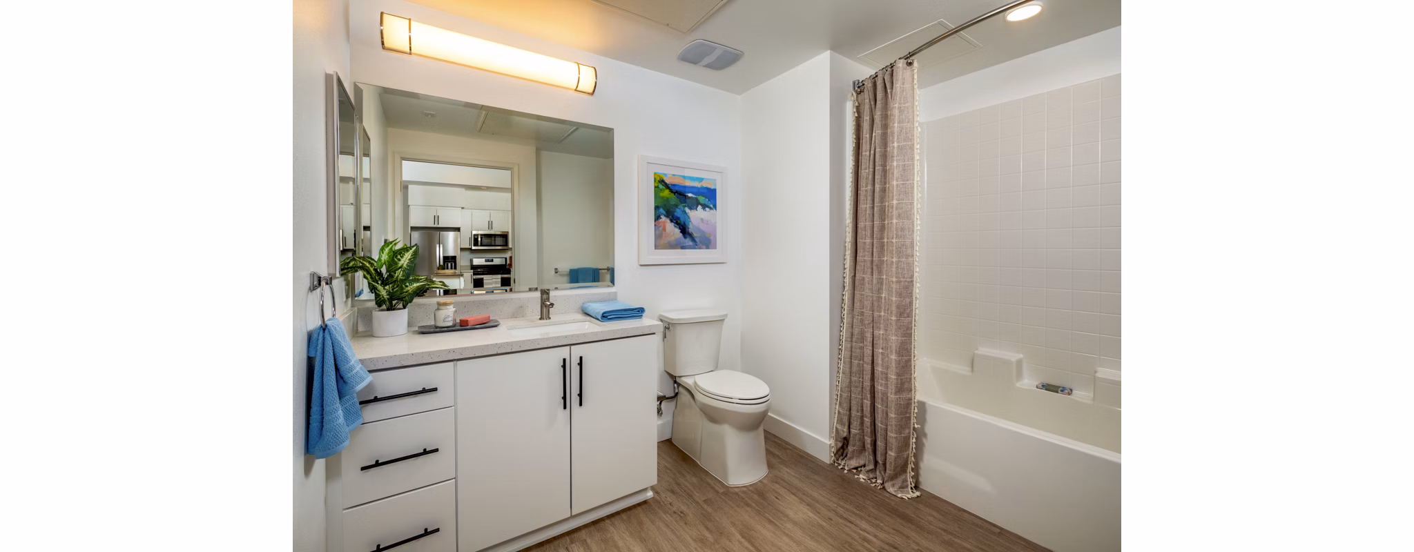 Modern bathroom with marble countertops and glass shower in Aston at Gateway Apartments