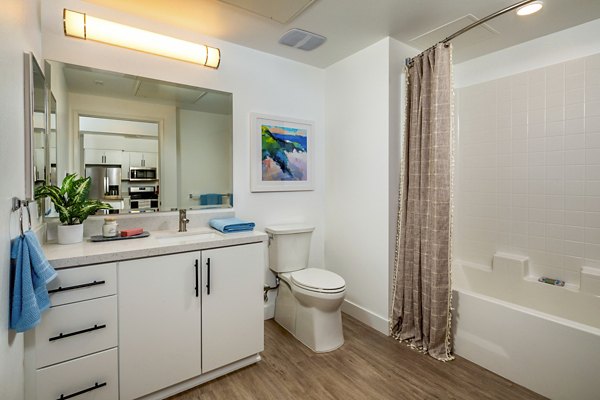 Modern bathroom with marble countertops and glass shower in Aston at Gateway Apartments