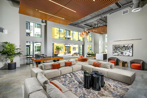 Elegant clubhouse featuring modern decor and ample seating at Aston at Gateway Apartments, a luxury living space