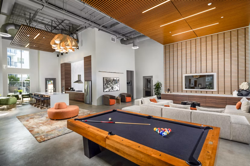 Aston at Gateway: Clubhouse game room with pool table and modern decor, luxury amenity at Greystar's upscale apartments