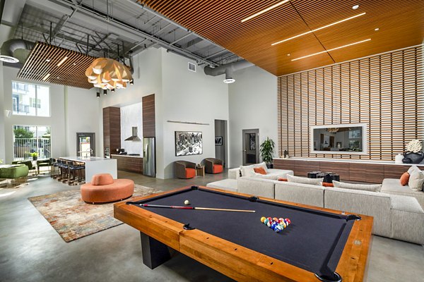 Aston at Gateway: Clubhouse game room with pool table and modern decor, luxury amenity at Greystar's upscale apartments