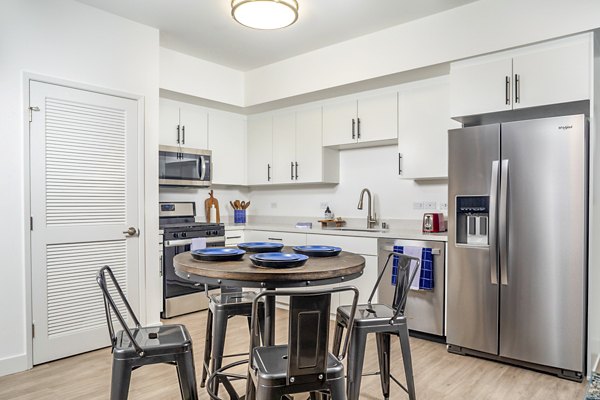 Dining area with modern decor and natural lighting at Aston at Gateway Apartments