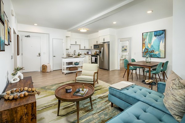 Spacious living room with modern decor featuring sleek furniture at Aston at Gateway Apartments, a Greystar luxury community