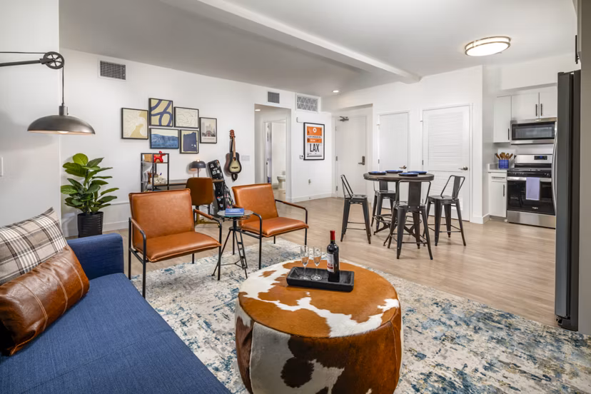 Spacious living room featuring modern decor and large windows in Aston at Gateway Apartments