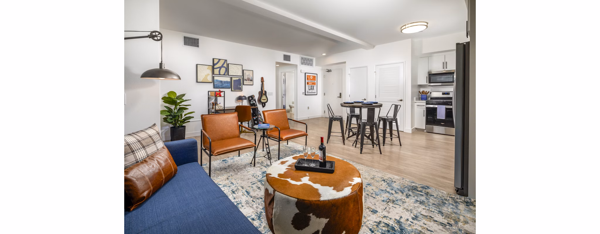 Spacious living room featuring modern decor and large windows in Aston at Gateway Apartments