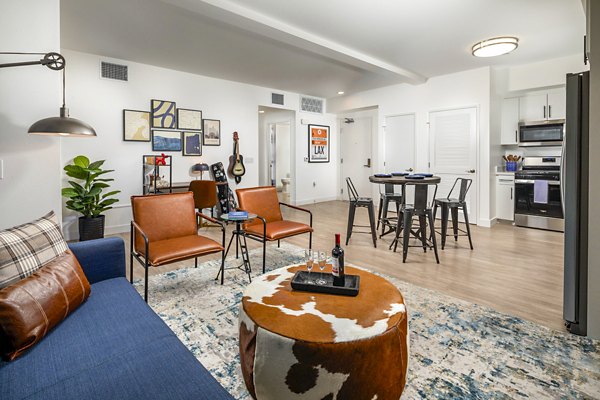 Spacious living room featuring modern decor and large windows in Aston at Gateway Apartments