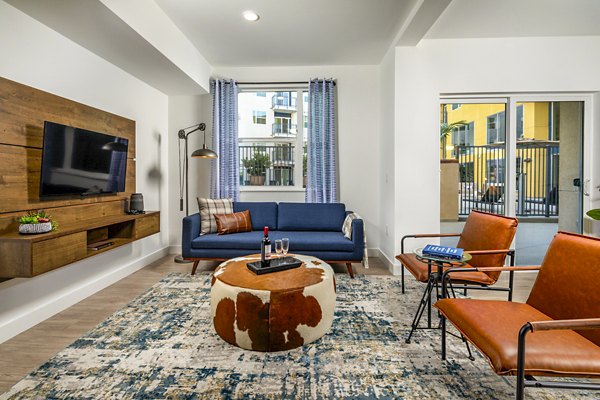 Stylish living room with modern decor and ample natural light at Aston at Gateway Apartments