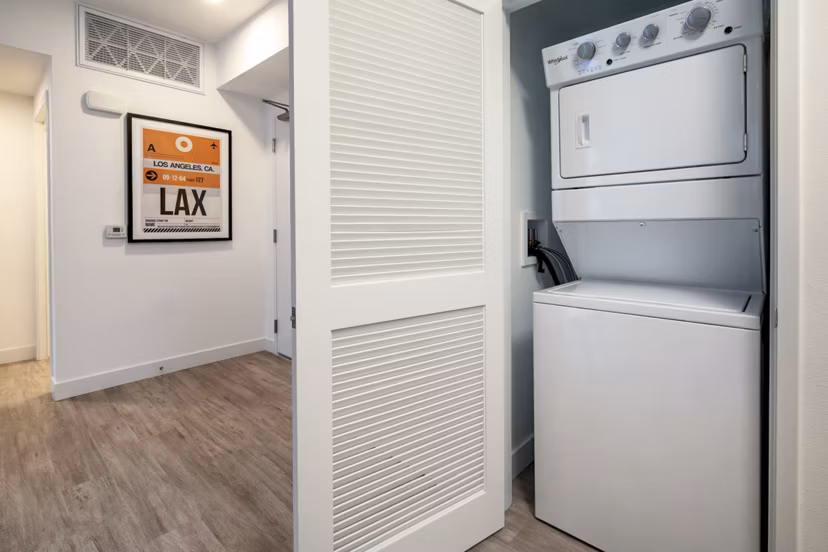 Laundry room with modern washers and dryers at Aston at Gateway Apartments, offering convenient amenities for residents
