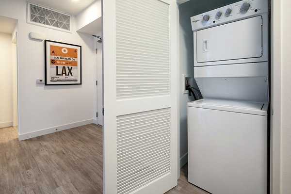 Laundry room with modern washers and dryers at Aston at Gateway Apartments, offering convenient amenities for residents