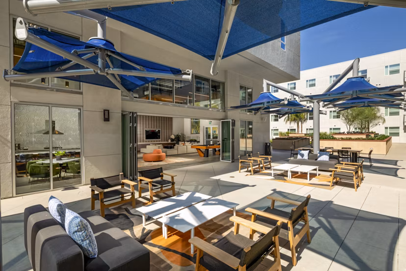 Inviting fire pit on patio at Aston at Gateway Apartments, offering cozy outdoor relaxation space