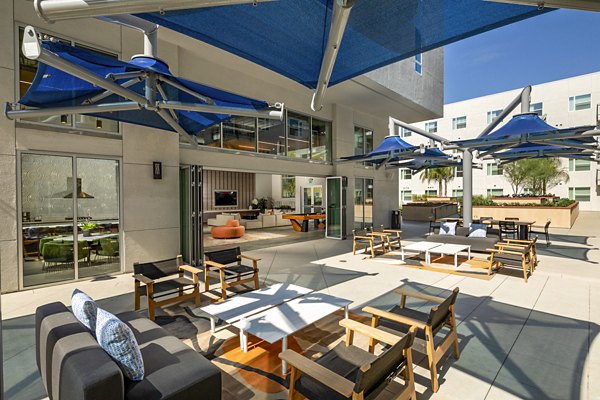 Inviting fire pit on patio at Aston at Gateway Apartments, offering cozy outdoor relaxation space