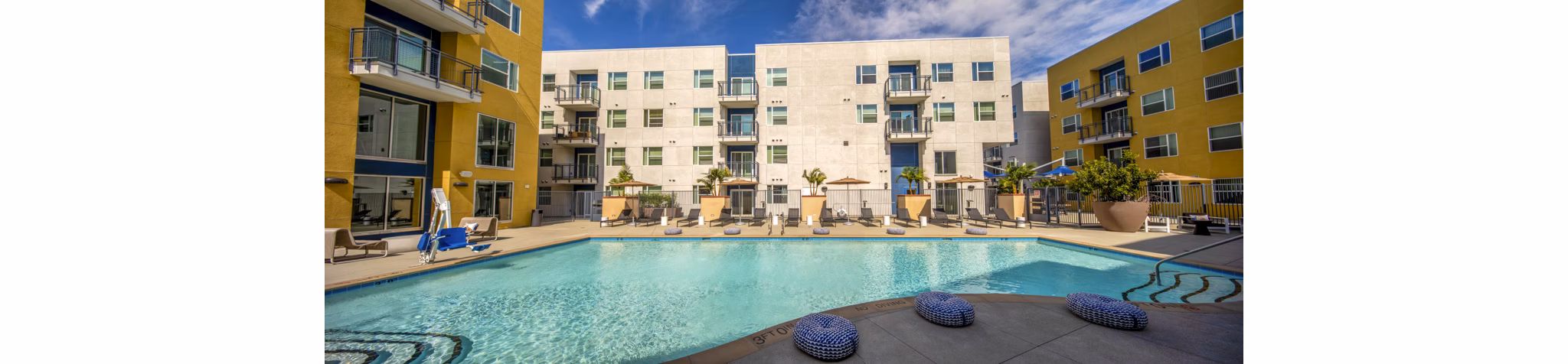 Resort-style pool with lounging areas at Aston at Gateway Apartments, perfect for relaxation and socializing
