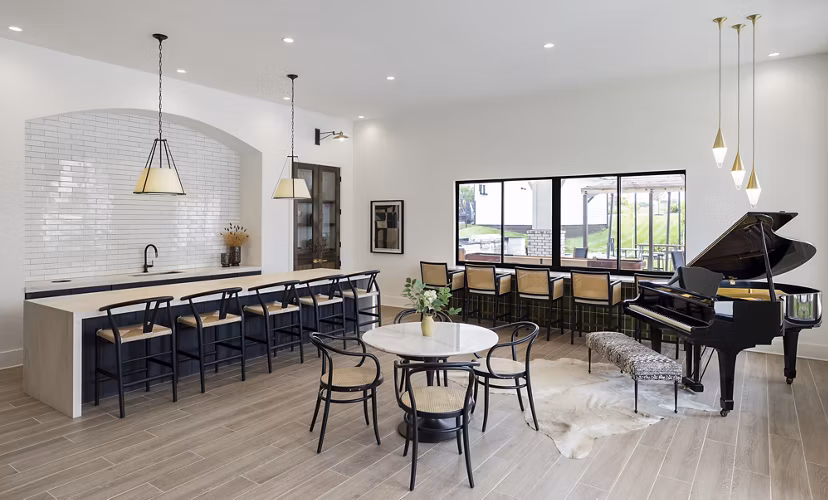 Modern clubhouse with cozy seating and pool table at Maxwell Apartments