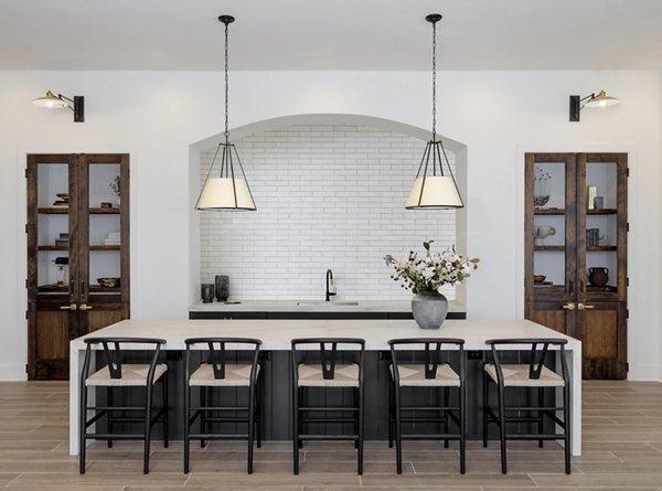 Maxwell Apartments: Modern clubhouse with luxurious seating and large windows in upscale residential community