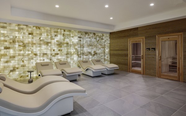 Serene spa area with lush plants and tranquil lighting at Maxwell Apartments, offering luxury amenities for relaxation and rejuvenation