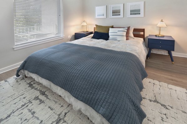 Spacious bedroom with modern decor at The Blake Apartments, offering luxury living in an upscale setting