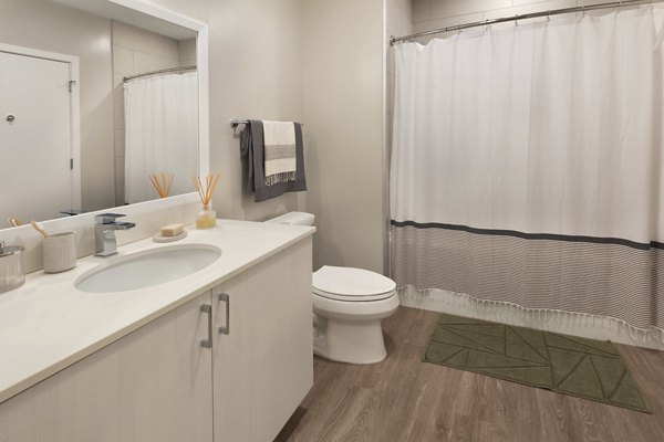 Modern bathroom featuring sleek fixtures and elegant tiles at The Blake Apartments