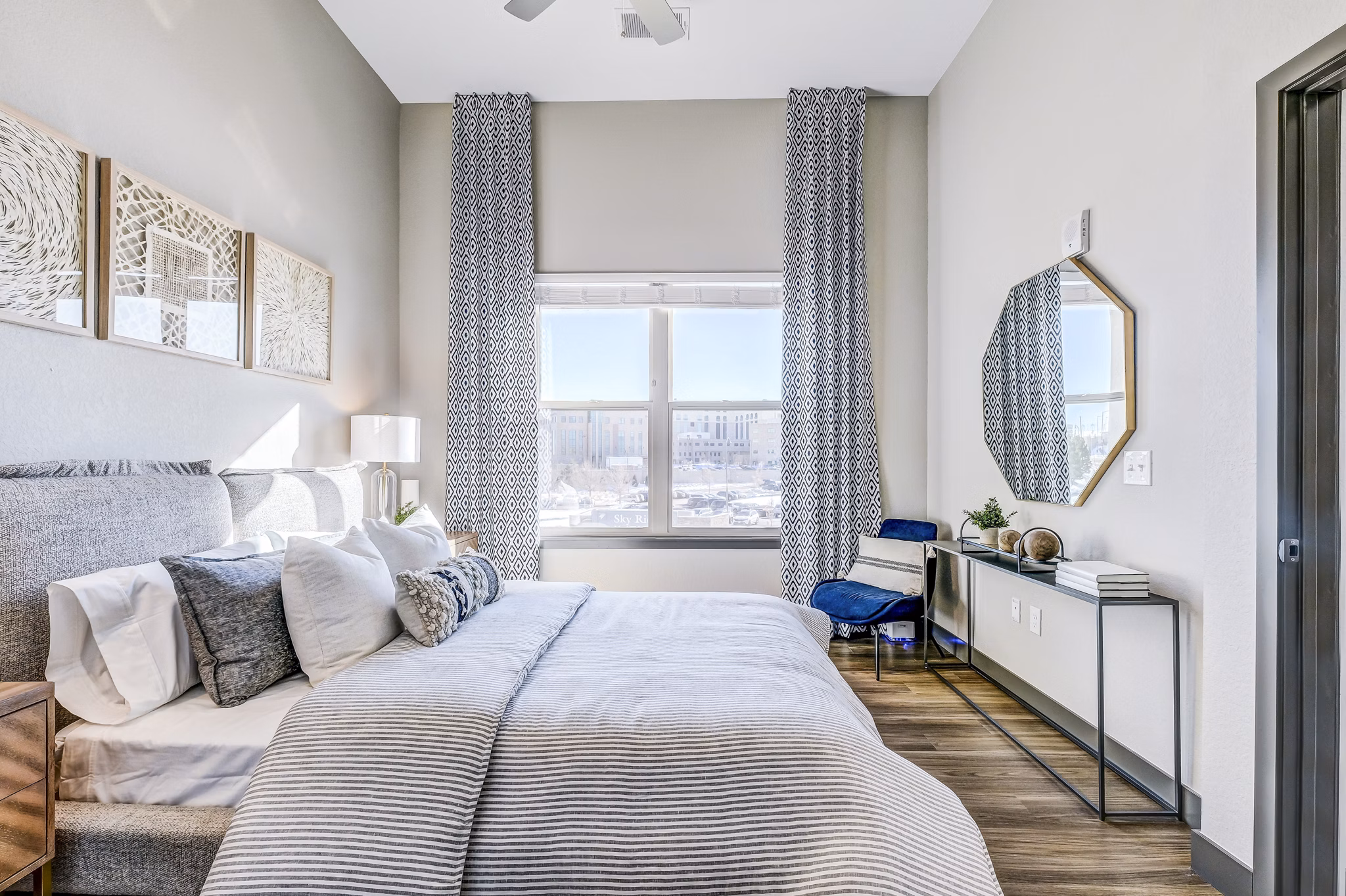 Cozy bedroom with modern decor at Novus Apartments, featuring plush bedding and contemporary design elements