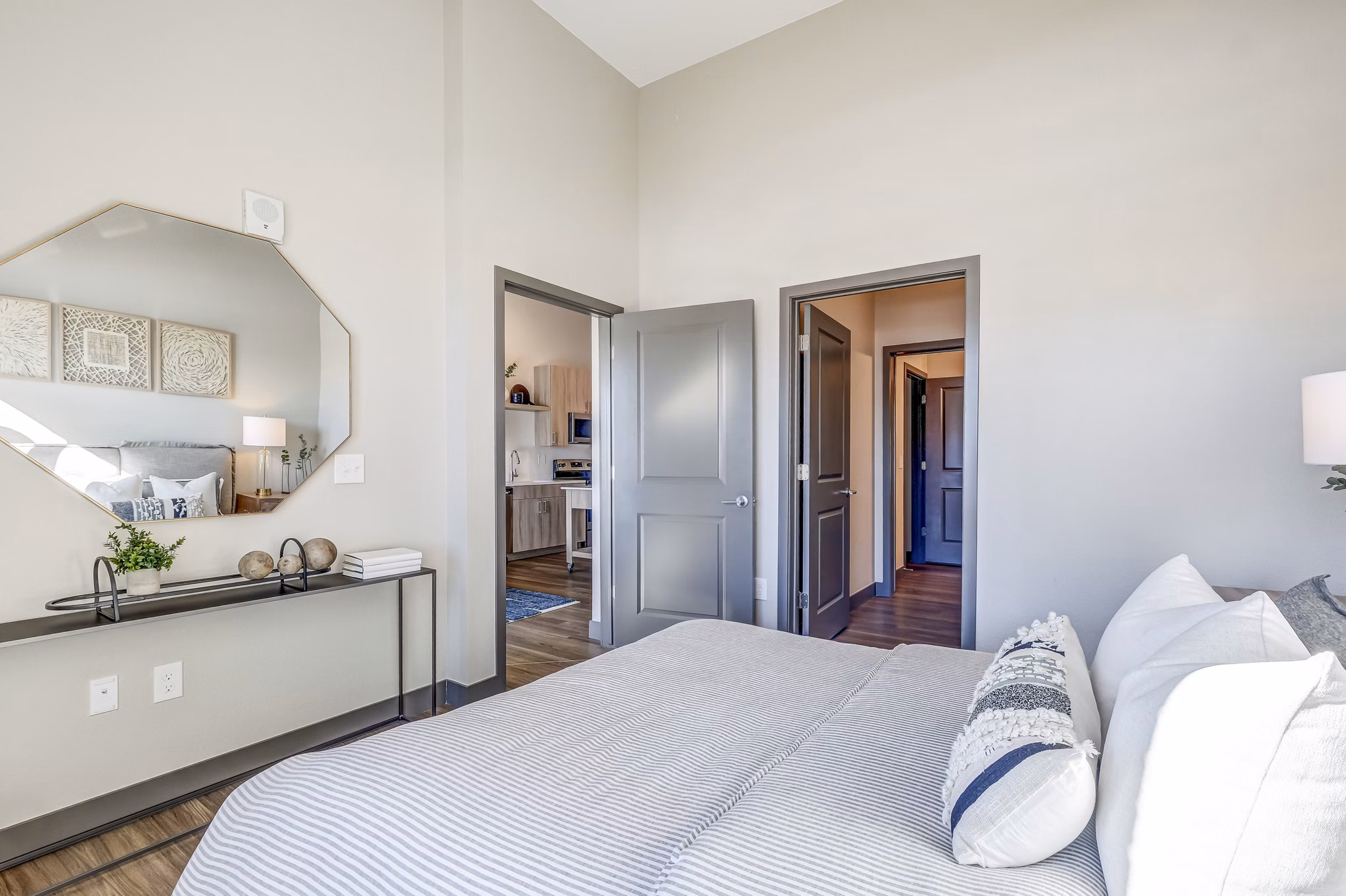 Modern bedroom with stylish dÃ©cor and ample natural light at Novus Apartments