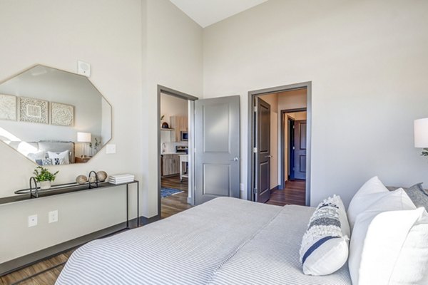 Modern bedroom with stylish dÃ©cor and ample natural light at Novus Apartments
